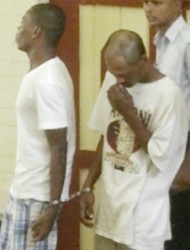 Rohan Teekaram (front right) being escorted back to the holding cell after his arraignment on April 24th, at the Georgetown Magistrates’ Courts.