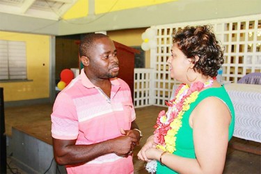 Minister Priya Manickchand discusses an issue with a parent following the consultation on Thursday (Ministry of Education photo)