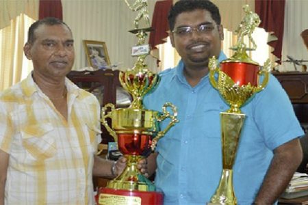  Minister of Tourism Irfaan Ali, right and Trophy Stall CEO Ramesh Sunich show off some of the trophies which will up for grabs at today’s sporting events of the Guyana Festival.
