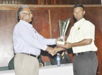 Guyana skipper Brian Sattaur receiving the winning trophy from Director of Sport Neil Kumar