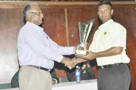 Guyana skipper Brian Sattaur receiving the winning trophy from Director of Sport Neil Kumar
