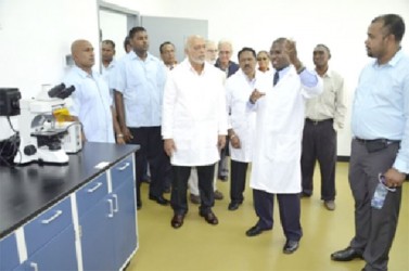 President Donald Ramotar being given a tour of the new lab by Dr. Dane Hartley (second from right), Manager Designate of the lab (second from right) (GINA photo) 