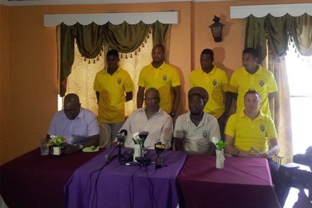 Alpha United head coach Wayne Dover (third from left sitting) addressing the gathering during the press conference while other members and players of the club inclusive of club President Odinga Lumumba (second from left sitting) look on.
