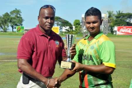 AYE, AYE  SKIPPER!  Guyana’s skipper Brian Sattaur receiving the winning trophy from Rawl Lewis.