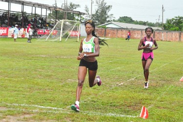 Grenada’s Kenisha Pascal about to cross the finish line way ahead in the 3000m. (Orlando Charles photo) 