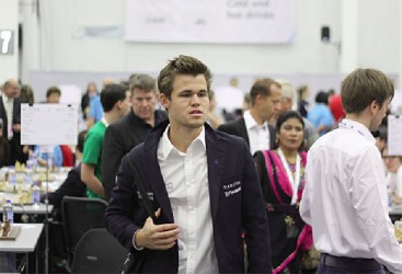 Undisputed world chess champion (classical, rapid and blitz) Magnus Carlsen (seen above) experienced two resounding defeats at the 2014 Tromso Olympiad. Competing on Board One for his home country of Norway, Carlsen lost to Germany’s Arkadij Naiditsch and Croatia’s Ivan Saric.  