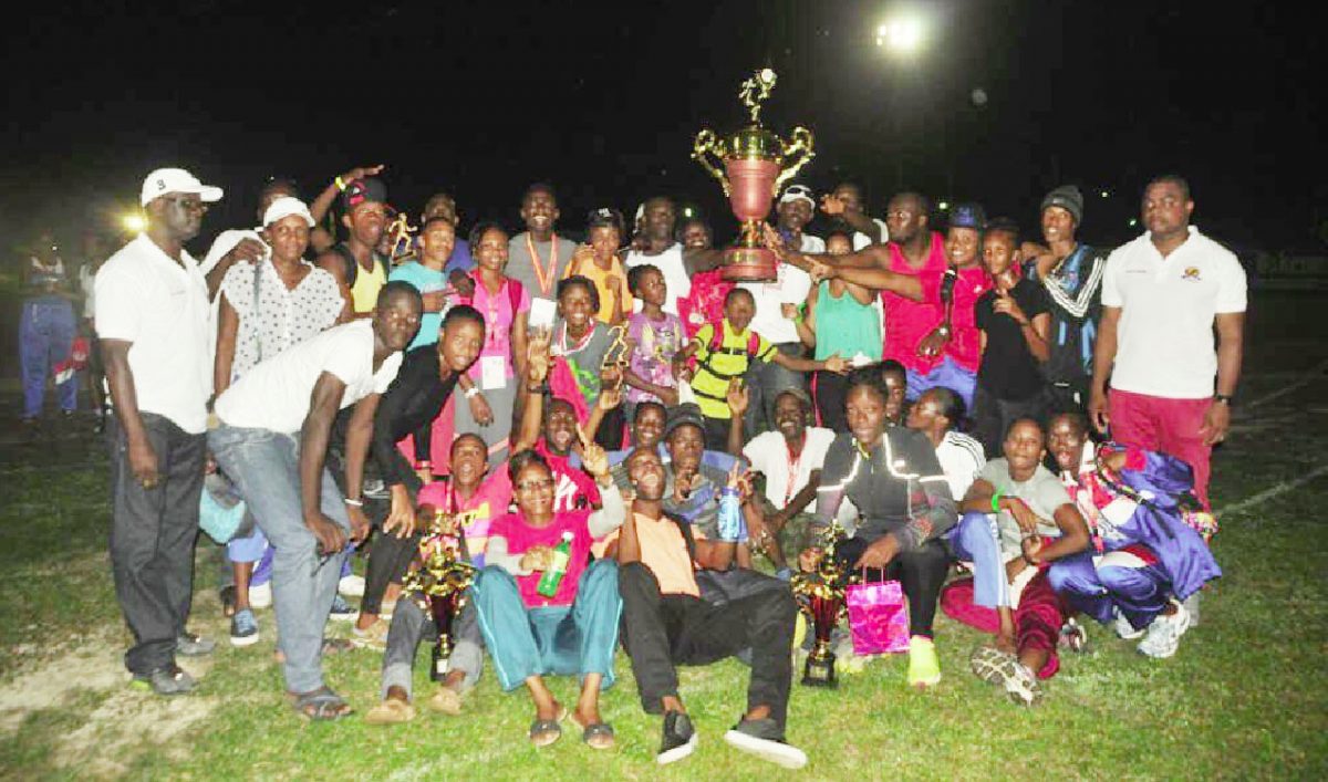 The Police Progressive Youth Club track and field outfit posing with the winner’s Boyce/Jefford Classic Trophy. (Orlando Charles photo)
