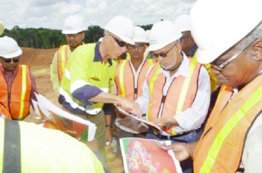 President Donald Ramotar along with Canadian High Commissioner to Guyana, Nicole Giles and several other Cabinet members yesterday visited the Guyana Goldfields, Aurora, Cuyuni operations.  In this GINA photo, Ramotar (second from right) and Minister of Public Works Robeson Benn (right) being briefed on progress of works by Chief Executive Officer Scot Caldwell. 