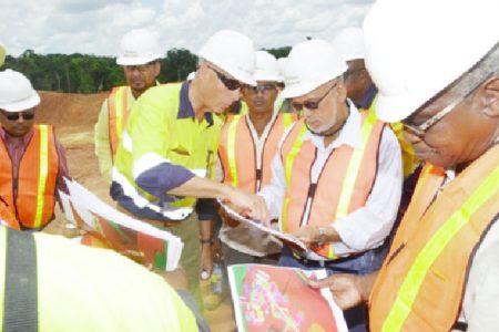 President Donald Ramotar along with Canadian High Commissioner to Guyana, Nicole Giles and several other Cabinet members yesterday visited the Guyana Goldfields, Aurora, Cuyuni operations.  In this GINA photo, Ramotar (second from right) and Minister of Public Works Robeson Benn (right) being briefed on progress of works by Chief Executive Officer Scot Caldwell.