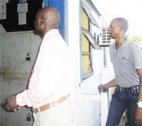 (from left) Inspector Thornton and Constable Forrester entering the Sparendaam Police Station following their arraignment on July 8. 