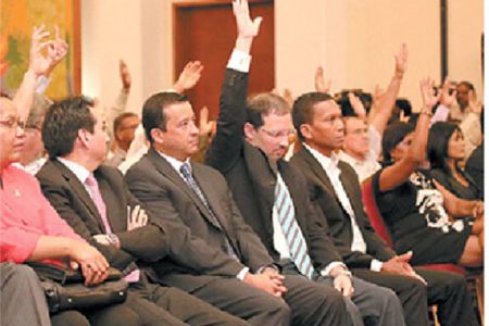 Newly-installed Trinidad Cement Limited (TCL) director Glenn Hamel-Smith, second from right, raises his hand in support of TCL’s new board during the company’s special compulsory shareholders meeting at the Radisson Hotel, Port-of-Spain, on Tuesday. Also in photo from left are new board members Alison Lewis, Carlos Pallero, Francisco Aguilera and Christopher Dehring. (Trinidad Guardian)