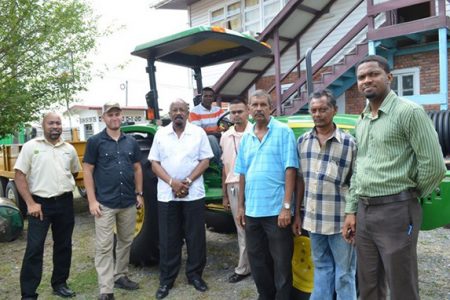   Local Government and Regional Development Minister Norman Whittaker (third from left) handing over the bobcat and tractor and trailer. (GINA photo)