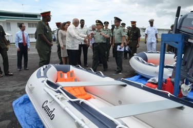 President Donald Ramotar (second from left) being briefed by Chinese military officials on the equipment. (GINA photo)