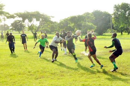 Ruggers practicing their passing yesterday at the National Park rugby field. (Orlando Charles photo)
