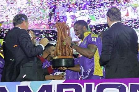 Captain of the Barbados Tridents team Kieron Pollard is all smiles as he receives the CPL Trophy following the rain affected final two Saturdays ago.