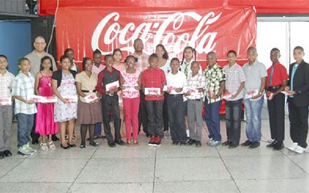 George McDonald, Co-Managing Director/Marketing Director (centre back row) and other executives of Banks DIH Limited pose with the 2014 bursary awardees following the presentation ceremony. (Banks DIH photo)