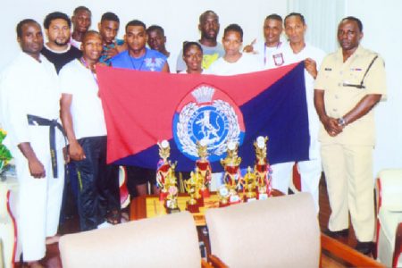 The Guyana Police Force Karate team with the Force Training Officer, Senior Superintendent Paul Williams in Police uniform (far right).
