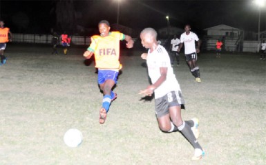 Golden Jaguars Provisional squad scorer Delroy Fraser (left) challenging a Den Amstel Porknockers for the possession of the ball during their 3-3 draw 