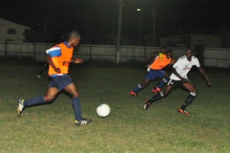 Shaquille Agard (left) of the Golden Jaguars Provisional squad in the process of playing a through pass which led to Delroy Fraser’s opening goal

