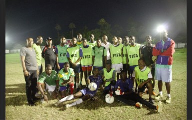 GFF President Christopher Matthias (centre) posing with the Golden Jaguars team and training staff during their final practice session at the Tucville Community ground 