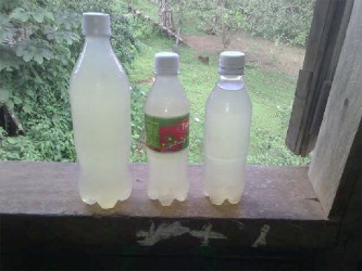 Bottles of contaminated water which were collected by residents.