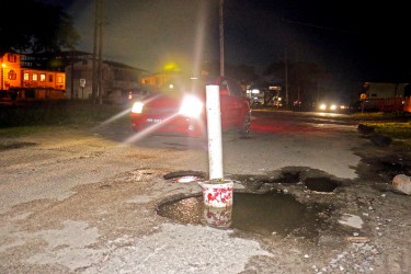 Persons in the neighbourhood had to place this large white pipe to warn motorists of the deep pothole at Thomas and Middle Sts which has damaged a lot of vehicles particularly during heavy rainfall when that part of the road is completely submerged.