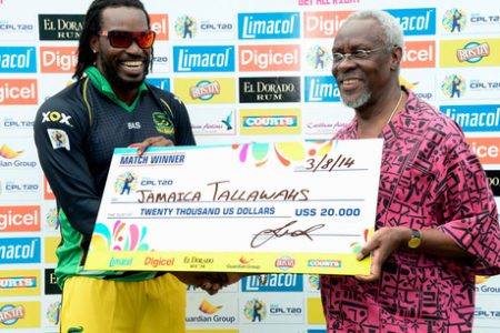 Former Prime Minister of Jamaica P.J. Patterson (right) presents Christopher Gayle, captain of the Jamaica Tallawahs, with the winners' cheque shortly after they defeated the Barbados Tridents in the Caribbean Premier League Twenty20 cricket match at Sabina Park on Sunday