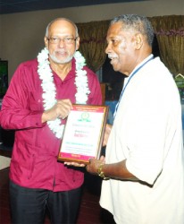 President Donald Ramotar honors legendary West Indies batsman Basil Butcher . (Orlando Charles photo)