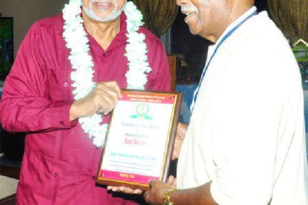 President Donald Ramotar honors legendary West Indies batsman Basil Butcher . (Orlando Charles photo)