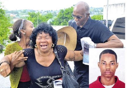 Evadne Hamilton (left), aunt of Mario Deane (right), weeps uncontrollably as her nephew’s body is whisked from the Cornwall Regional Hospital morgue by a hearse from Madden’s Funeral Home. (Jamaica Observer photo)