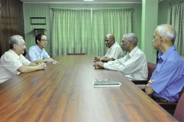 China’s Ambassador Zhang Limin (left) in conversation with Leader of the Opposition, David Granger (centre left)  