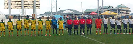 The starting 11 of the Golden Jaguars (left) lining up before the start of their CFU Cup Qualification tourney opener against Dominica. (Picture courtesy of vibesantigua.com).
