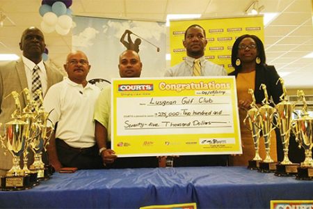 Courts Marketing Manager, Pernell Cummings (2nd right) and Public Relations Officer, Roberta Ferguson (right) with the sponsorship cheque in the presence of David Mohamed (3rd left), Chatterpaul Deo (2nd left) and Guy Griffith.
