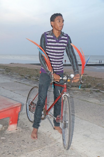 Heritage style? This young man was seen on the seawall at Kingston yesterday with his bicycle decked out with feathers. (Photo by Arian Browne)