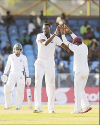 Sulieman Benn celebrates another wicket with Darren Bravo during day three of the 1st Test between the  West Indies  and Bangladesh at Arnos Vale Sports Complex, St. Vincent yesterday. (Photo: WICB/BrooksLaTouche) 