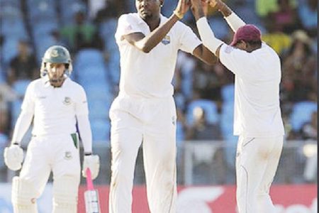 Sulieman Benn celebrates another wicket with Darren Bravo during day three of the 1st Test between the  West Indies  and Bangladesh at Arnos Vale Sports Complex, St. Vincent yesterday. (Photo: WICB/BrooksLaTouche)
