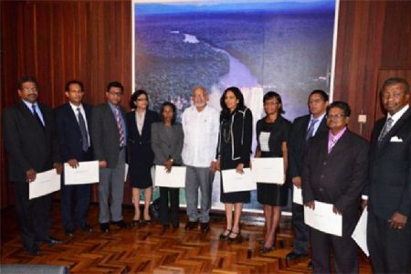 President Donald Ramotar (centre) poses with the new notaries. (GINA photo)