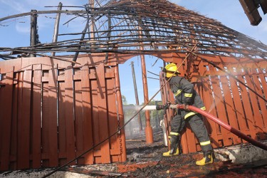 A fireman getting close up after fire razed the Umana Yana yesteray (Arian Browne photo)