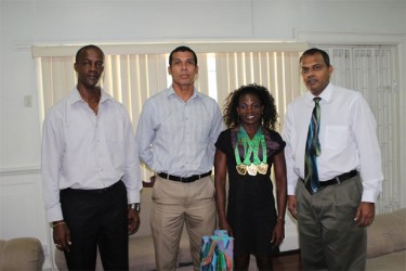Alisha Fortune flanked by Minister of Sport, Dr. Frank Anthony (far right), Silas Brummel and Alfred King. 