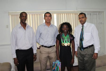 Alisha Fortune flanked by Minister of Sport, Dr. Frank Anthony (far right), Silas Brummel and Alfred King.
