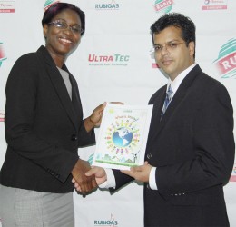 This RUBIS photo shows Rhonda Johnson receiving a copy of the booklet from Dr Mahender Sharma 