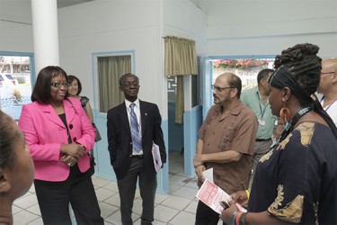 PAHO Director Dr. Carissa Etienne (left) interacts with Health Minister Bheri Ramsaran (third from left) and PAHO Country Representative Dr. William Adu-Krow (centre) yesterday during her visit to the Campbellville Health Centre. (Arian Browne photo) 
