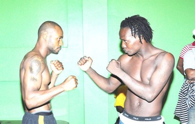 Jamaica’s Sakima Mullings (left) and Derrick Richmond square off last night at the Regency Hotel after making weight for their ‘Battle of Contenders’ headline bout. (Orlando Charles photo) 