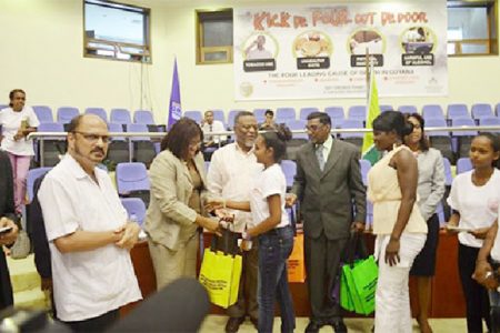 In this Government Information Agency (GINA) photo PAHO/WHO Director, Dr. Carissa Etienne (second from left) handing over testing equipment to members of the Wellness Warriors Club.