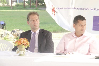 Head of the Cooperation Department of the European Union Ewourt Sandker (left) sits with Local Government Permanent Secretary Collin Croal at the launch of the Cooperation for Community Transformation Project in East Ruimveldt.    