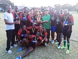 The victorious Hornets outfit posing with the GRFU 10s league trophy and medals which was presented by president of the union, Peter Green.