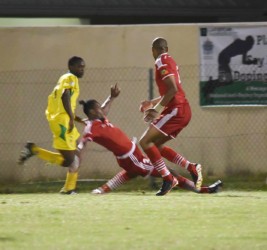 Shaquille Agard (left) on the attack while being challenged by his St. Kitts and Nevis marker during Guyana’s final match in the CFU Caribbean Cup Qualification tourney.