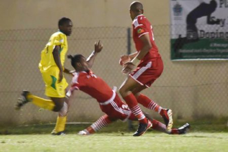 Shaquille Agard (left) on the attack while being challenged by his St. Kitts and Nevis marker during Guyana’s final match in the CFU Caribbean Cup Qualification tourney.