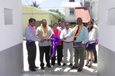 Sharir Chan (second from right) being assisted by Prime Minister Samuel Hinds (right) and Regional Chairman, David Armogan (second from left) and CEO of the BRHA, Vishwa Mahadeo (left) to cut the ribbon to the new unit.