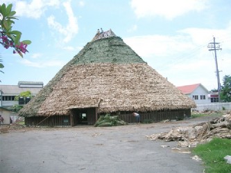 Photo of Wai Wai repairing the roof of the Umana Yana in 2010. Photo courtesy of Anna Isles. 